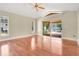 Large bedroom featuring gleaming hardwood floors and sliding door access to screened lanai and pool area at 1512 Adriatic Dr, Ocoee, FL 34761
