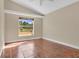 Bright bedroom with large window, neutral walls, and stylish tile flooring for easy maintenance at 1512 Adriatic Dr, Ocoee, FL 34761