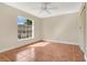 Cozy bedroom with a bright window and tile flooring providing a comfortable living space at 1512 Adriatic Dr, Ocoee, FL 34761
