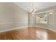 Inviting dining room featuring hardwood floors, neutral walls, with picture-frame moulding and a modern chandelier at 1512 Adriatic Dr, Ocoee, FL 34761