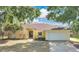 Inviting one-story home with a two-car garage, mature trees, and a well-manicured front yard at 1512 Adriatic Dr, Ocoee, FL 34761
