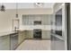 Modern kitchen featuring gray cabinets, stainless steel appliances, granite countertops, and tile backsplash at 1512 Adriatic Dr, Ocoee, FL 34761