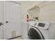 Functional laundry room with modern washer and dryer, and convenient storage shelving at 1512 Adriatic Dr, Ocoee, FL 34761
