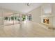 Spacious living room with fireplace, views of the lanai and pool through sliding glass doors and windows at 1512 Adriatic Dr, Ocoee, FL 34761