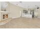 Open-concept living area with fireplace and views into the modern gray kitchen with a granite countertop at 1512 Adriatic Dr, Ocoee, FL 34761
