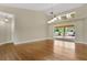 Bright living room featuring hardwood floors, lots of natural light, and sliding glass doors to the pool at 1512 Adriatic Dr, Ocoee, FL 34761