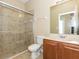 Bathroom featuring a glass shower, toilet, sink, and wooden cabinetry at 173 Donner Dr, Winter Garden, FL 34787