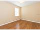 Neutral bedroom featuring wood flooring and natural light from a window at 173 Donner Dr, Winter Garden, FL 34787