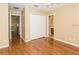 A bedroom featuring hardwood floors, a closet with white doors, and access to the attached bathroom at 173 Donner Dr, Winter Garden, FL 34787