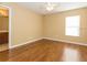 Spacious bedroom featuring hardwood floors, a ceiling fan, and natural light from a bright window at 173 Donner Dr, Winter Garden, FL 34787