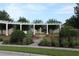 A landscaped community space featuring a fountain, bench, and a pergola walkway at 173 Donner Dr, Winter Garden, FL 34787