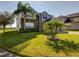 Two-story home with palm trees in the front yard, brick accents, and a well manicured lawn at 173 Donner Dr, Winter Garden, FL 34787