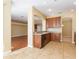Open kitchen with tile floor and a view of the hardwood-floored living spaces at 173 Donner Dr, Winter Garden, FL 34787