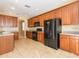 Well-equipped kitchen with extensive cabinetry, modern black appliances, and tile flooring at 173 Donner Dr, Winter Garden, FL 34787