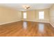 Large living room featuring wood floors, multiple windows, and a ceiling fan at 173 Donner Dr, Winter Garden, FL 34787