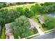 An aerial view of a house with a manicured lawn, mature trees, and proximity to a golf course at 1937 Crystal Downs Ct, Oviedo, FL 32765