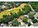 An aerial shot featuring a golf course community with homes, mature trees, and inviting swimming pools at 1937 Crystal Downs Ct, Oviedo, FL 32765