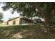 The home's backyard shows the screened-in lanai and a large, grassy space at 1937 Crystal Downs Ct, Oviedo, FL 32765