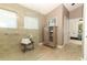 Modern bathroom with a glass-enclosed shower, beige tiles, and a storage cabinet at 1937 Crystal Downs Ct, Oviedo, FL 32765