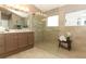 Bathroom with a large glass shower, double vanity, and neutral tile throughout at 1937 Crystal Downs Ct, Oviedo, FL 32765