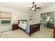 Bright bedroom with a ceiling fan, neutral carpet, and sliding door access to a screened patio at 1937 Crystal Downs Ct, Oviedo, FL 32765