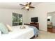 A bright bedroom offers great natural light from a glass sliding door to an outdoor area at 1937 Crystal Downs Ct, Oviedo, FL 32765