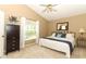 Bedroom with carpeted floors, ceiling fan, and window letting in plenty of natural light at 1937 Crystal Downs Ct, Oviedo, FL 32765