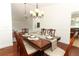 Formal dining space with hardwood floors, a table set for six and bright lighting at 1937 Crystal Downs Ct, Oviedo, FL 32765