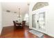 Dining room with wooden table set for six, hardwood floors and modern lighting at 1937 Crystal Downs Ct, Oviedo, FL 32765