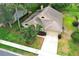 Aerial view of a single-Gathering home; well-maintained lawn, mature trees, and a paved driveway at 1937 Crystal Downs Ct, Oviedo, FL 32765