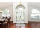 Inviting foyer with double front doors, hardwood floors, and lots of natural light at 1937 Crystal Downs Ct, Oviedo, FL 32765
