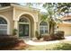 Elegant entryway features double doors with decorative glass and arched windows at 1937 Crystal Downs Ct, Oviedo, FL 32765