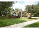 Charming single-story home featuring mature landscaping, manicured lawn, and a welcoming entrance at 1937 Crystal Downs Ct, Oviedo, FL 32765