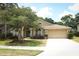 Charming single-story home with mature landscaping, manicured lawn, and a two-car garage at 1937 Crystal Downs Ct, Oviedo, FL 32765