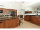 Gourmet kitchen offers granite counters, island seating, stainless appliances, and custom wood cabinetry at 1937 Crystal Downs Ct, Oviedo, FL 32765
