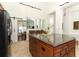 Spacious kitchen island with granite countertops and storage in an open-concept floor plan at 1937 Crystal Downs Ct, Oviedo, FL 32765