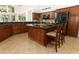 Open kitchen featuring an island, granite countertops, wooden cabinetry, and stainless steel appliances at 1937 Crystal Downs Ct, Oviedo, FL 32765