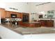Spacious kitchen with granite counters, stainless appliances, track lighting, and an island with seating at 1937 Crystal Downs Ct, Oviedo, FL 32765
