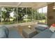 Lanai with outdoor furniture overlooks a large backyard and has views of the beautiful scenery at 1937 Crystal Downs Ct, Oviedo, FL 32765