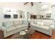 Open-concept living room boasts hardwood floors and modern touches like the mirrored wall art at 1937 Crystal Downs Ct, Oviedo, FL 32765