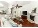 Inviting living room with fireplace, ceiling fan, and view into the kitchen and out to the lanai at 1937 Crystal Downs Ct, Oviedo, FL 32765