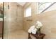 Walk-in shower featuring neutral tile, a grab bar, and a window for natural light at 1937 Crystal Downs Ct, Oviedo, FL 32765