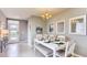 Open-concept dining space featuring an elegant chandelier, decorative table setting, and neutral wall colors at 194 Amberwood Way, Umatilla, FL 32784