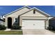 Charming single-Gathering home with a two-car garage, neat landscaping, and neutral color scheme at 194 Amberwood Way, Umatilla, FL 32784