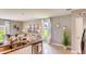 Modern kitchen flowing into the living room, featuring granite countertops and stainless steel appliances at 194 Amberwood Way, Umatilla, FL 32784