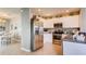 Modern kitchen featuring stainless steel appliances, white cabinetry, and an open view to dining room at 194 Amberwood Way, Umatilla, FL 32784