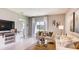 Bright living room featuring comfortable seating and decorative furniture with scenic lake view at 194 Amberwood Way, Umatilla, FL 32784