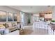 Spacious living room with decorative wall art and modern furnishings near the open kitchen at 194 Amberwood Way, Umatilla, FL 32784