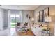 Well-lit living room showcasing view of the lake through sliding glass door and stylish decor at 194 Amberwood Way, Umatilla, FL 32784
