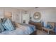 Comfortable bedroom featuring a wooden dresser, round decorative mirror, and coordinating throw pillows adding style at 198 Amberwood Way, Umatilla, FL 32784